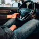 person holding black Honda car steering wheel